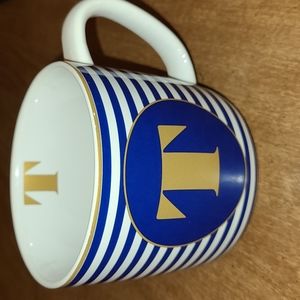 Navy blue and gold coffee mug with initial "T"